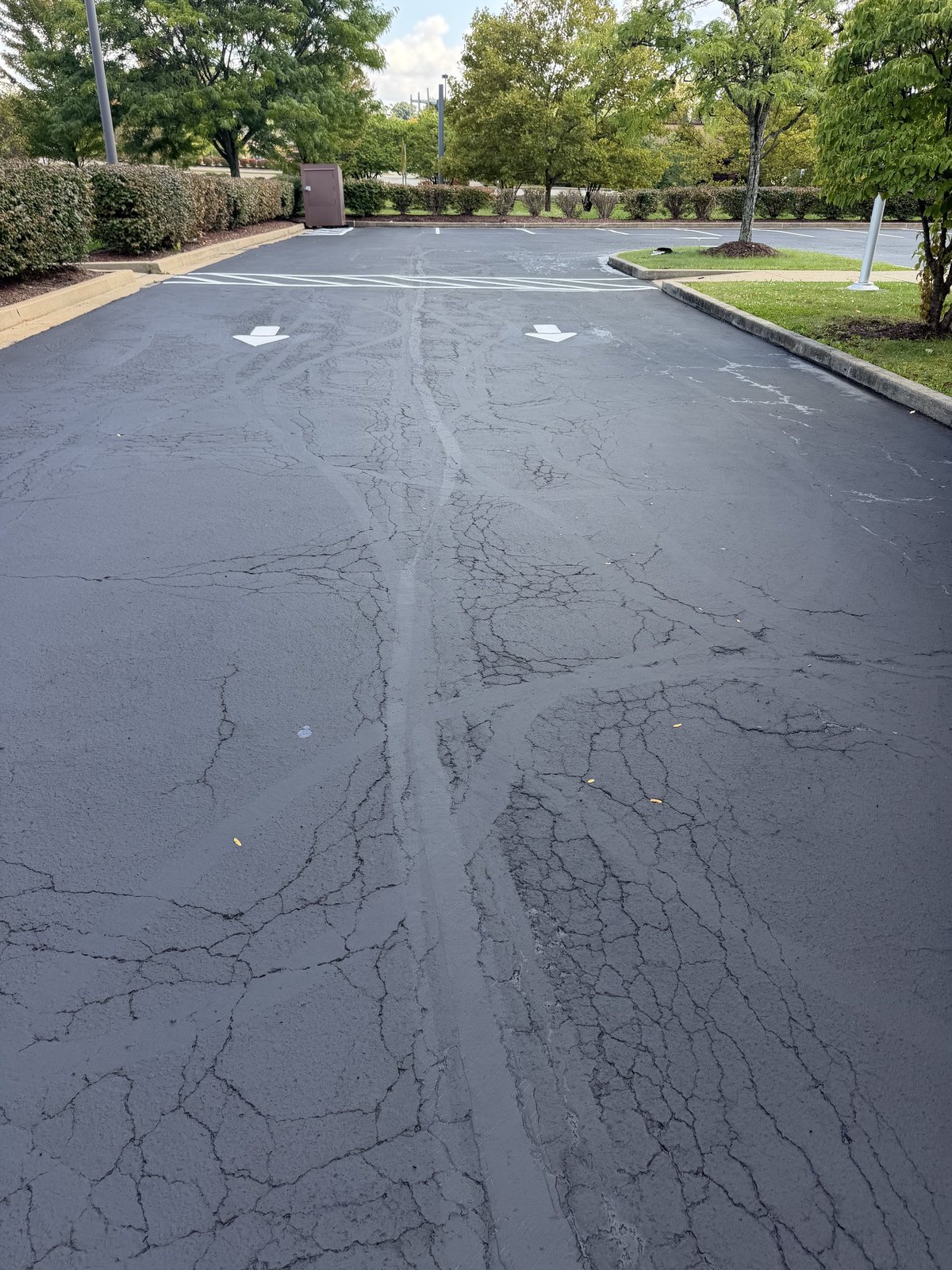 A long parking lot lane after a fresh coat of sealcoat